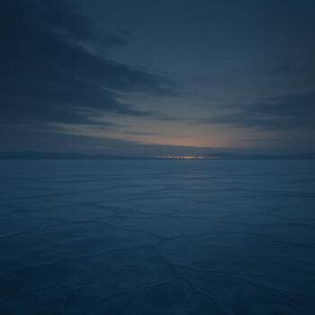 Едва заметное свечение далёкого города над линией горизонта и замёрзшим озером